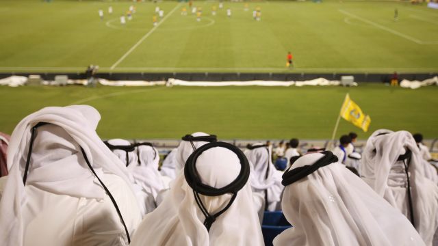 Fans wearing traditional local dress attend the Gharafa vs. Kharaitiyat Qatar Stars League football match in 2011.