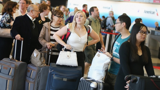 Passengers wait in line at O'Hare International Airport in Chicago in 2014.