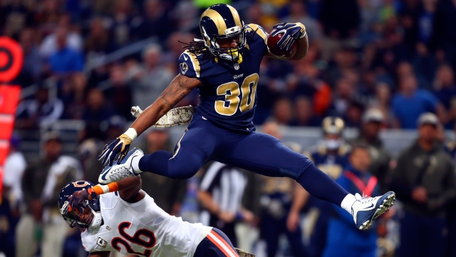 Todd Gurley #30 of the St. Louis Rams leaps over Antrel Rolle #26 of the Chicago Bears.