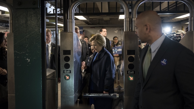 Hillary Clinton tries to swipe her MetroCard to get on the subway.