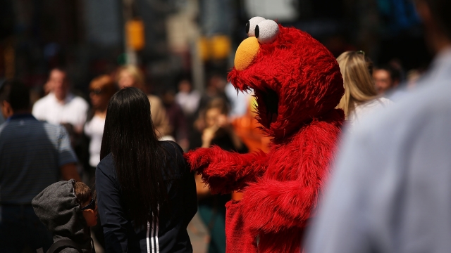 A person dressed as Elmo in Times Square.