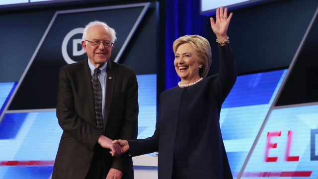 Clinton and Sanders shake hands before a Democratic debate in 2016.