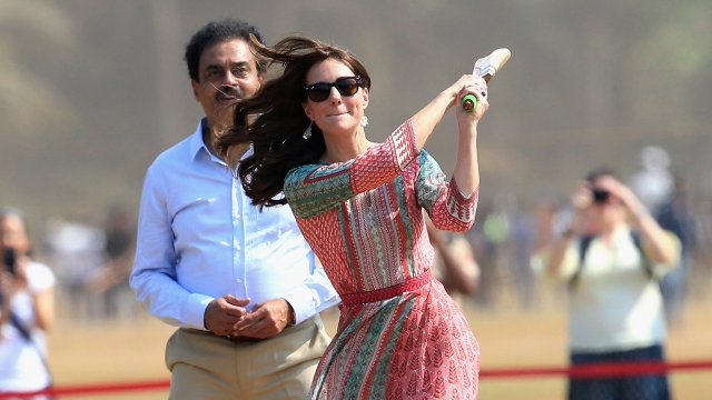 Catherine, Duchess of Cambridge plays cricket during a visit to meet children from Magic Bus