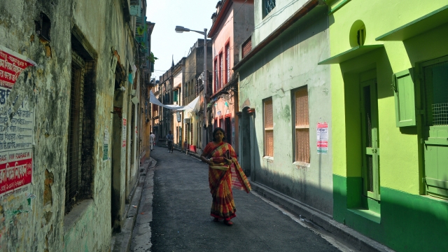 Woman walks in street of Kolkata, India.