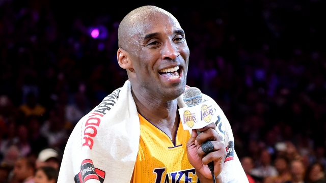 Kobe Bryant, No. 24 of the Los Angeles Lakers, addresses the crowd after scoring 60 points in his final NBA game.