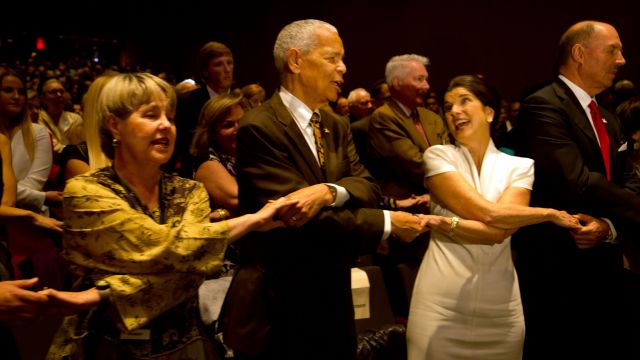 Julian Bond, Pamela Horowitz and Luci Baines Johnson link arms while singing "We Shall Overcome" at the Civil Rights Summit.