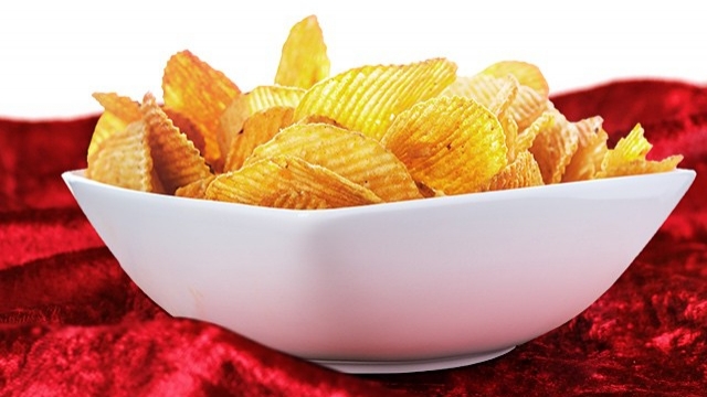 This image shows a bowl full of Ruffles potato chips.