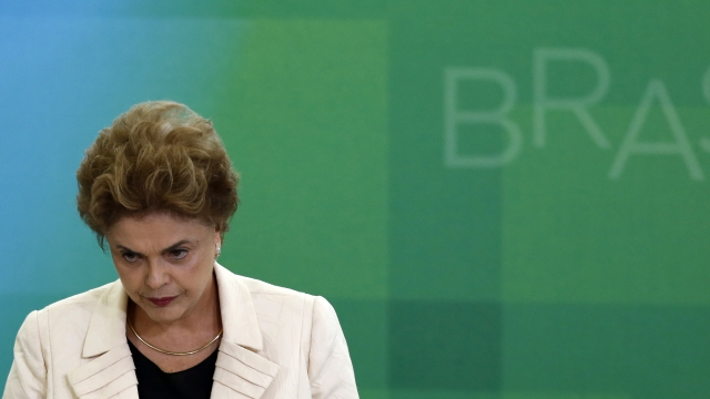 azil President Dilma Rousseff looks on as former president, Luiz Inacio Lula da Silva, is sworn in as the new chief of staff.