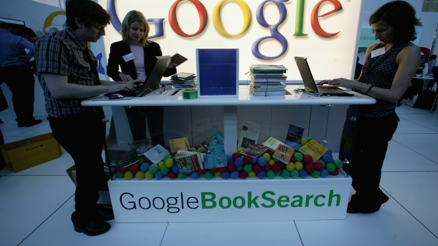 Employees of Google stand at the company's booth at the Frankfurt book fair.