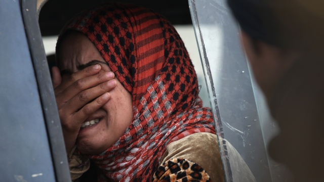 A woman cries after her family was rejected to enter a Kurdish-controlled area from an ISIS-held village near Sinjar, Iraq.