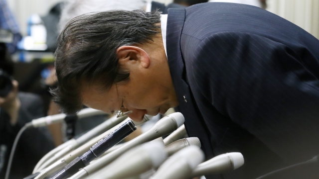 Mitsubishi Motors President Tetsuro Aikawa bows during a press conference on April 20, 2016 in Tokyo.