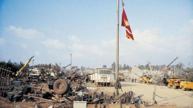 The Marine Corps. colors above the wreckage of a U.S. barracks in Beirut.