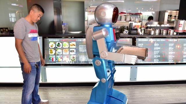A robot waiter delivers meals for customers at a robot-themed restaurant in China.