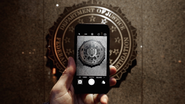 The official seal of the Federal Bureau of Investigation is seen on an iPhone's camera screen.