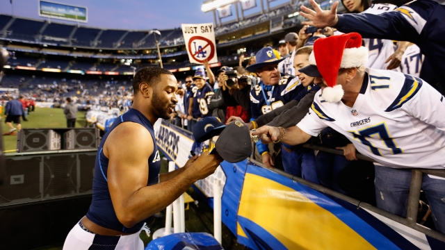 Adrian Phillips of the San Diego Chargers signs fans memorabilia after a game against the Miami Dolphins in 2015.