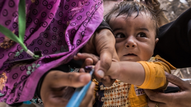 Muhammad, 12 months, is held by his mother, displaced from her home due to the Pakistan Army's latest Military offensive.