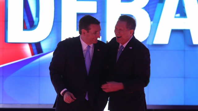 Republican presidential candidates Sen. Tec Cruz (R-TX) and Ohio Gov. John Kasich are seen during a broadcast break