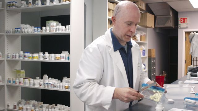 Pharmacist Howard Brooker fills a prescription at Adams Discount Pharmacy in Glenside, Pennsylvania.