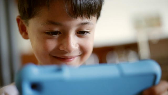 A child plays on his Amazon tablet.