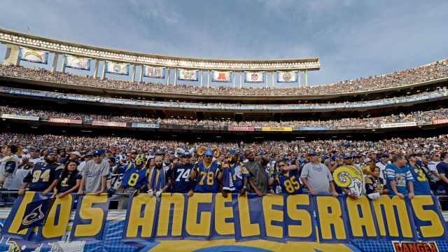 Fans of the St. Louis Rams hold a 'Los Angeles Rams' sign against the San Diego Chargers during their NFL Game
