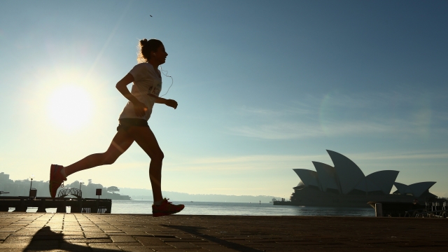 A woman runs along the foreshore at Sydney Harbour in Australia.