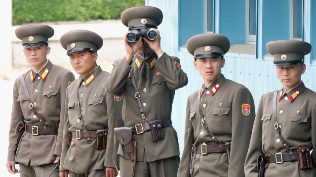 North Korean soldiers look at the south side.