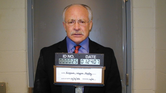 Former Fox News commentator Wayne Simmons, pictured here in a mug shot, pleaded guilty to major fraud against the U.S.
