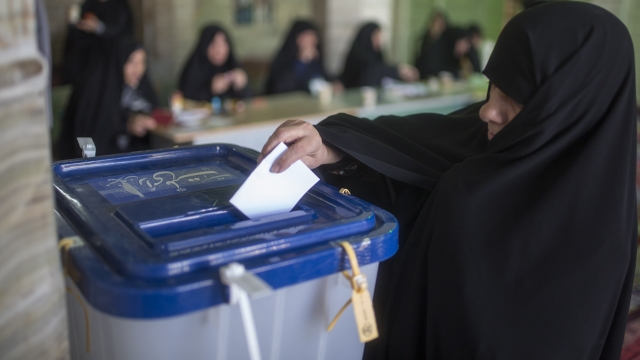 An Iranian woman votes during the country's parliamentary elections.