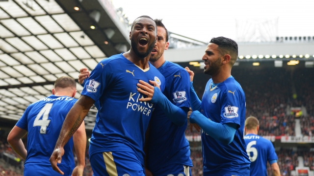 Wes Morgan of Leicester City celebrates scoring his team's opening goal with teammates during a match with Manchester United.
