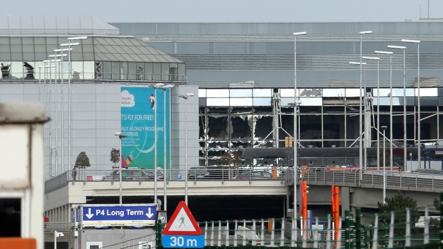 The glass front of the Brussels Airport departure hall appears to be blown out after terrorist attacks.