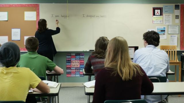 Photo of a teacher in front of a classroom of students.