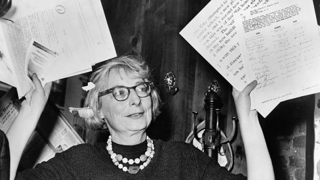Jane Jacobs, chairman of the Committee to Save the West Village, holds up documentary evidence at a press conference.