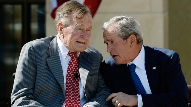 Former President George W. Bush talks to his father President George H.W. Bush.