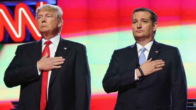 Donald Trump and Sen. Ted Cruz listen to the national anthem.
