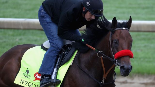 Exercise rider Jonny Garcia takes Nyquist over the track during training for the Kentucky Derby at Churchill Downs.