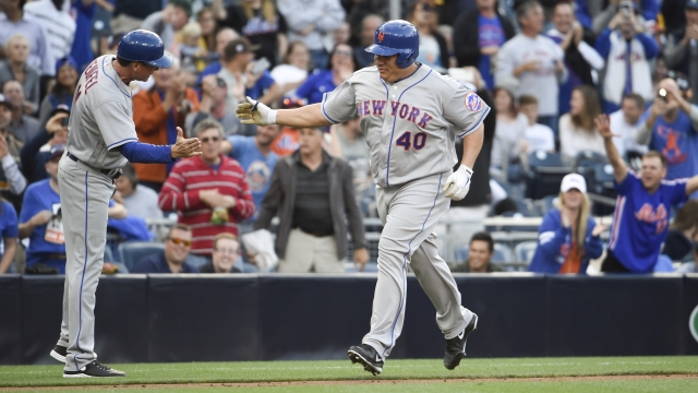 Bartolo Colon of the New York Mets, right, is congratulated after hitting a two-home run home run, the first of his career.