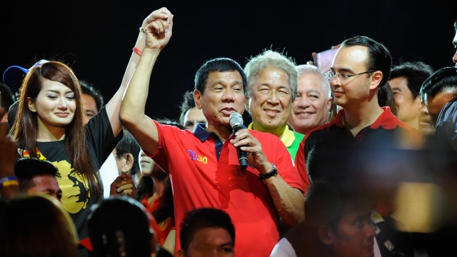 Rodrigo Duterte gestures during his final campaign rally