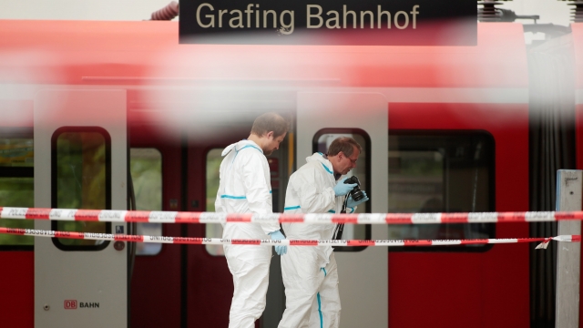 German forensics specialists secure the crime scene after a deadly knife attack on May 10, 2016, in Bavaria.