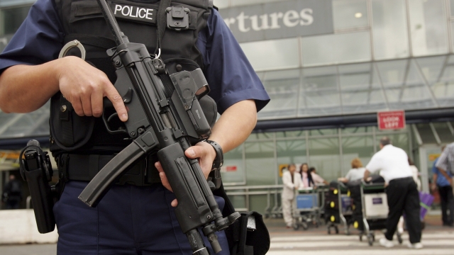 An armed British police officer patrols outside of Heathrow Airport in August 2006 in London.
