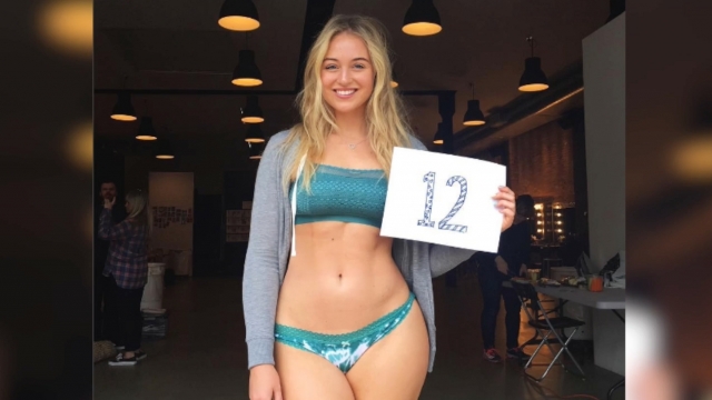Model Iskra Lawrence participates in People magazine's #ShareYourSize campaign by holding up a sign with her size on it.