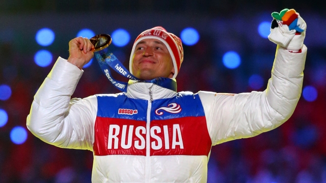 Gold medalist Alexander Legkov of Russia celebrates winning the Men's 50 km Mass Start Free during the 2014 Sochi Olympics.