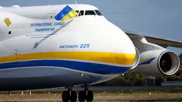 A Pilot waves a Ukrainian flag from the cockpit window after landing the Antonov AN-225.