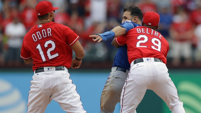 Adrian Beltre #29 of the Texas Rangers holds Jose Bautista #19 of the Toronto Blue Jays after being punched by Rougned Odor.