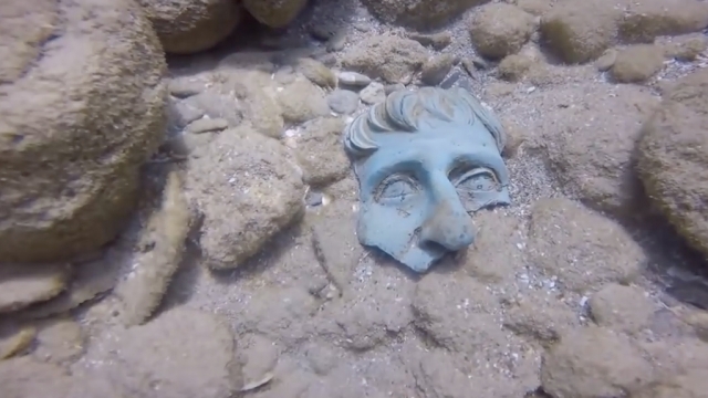A piece of a sculpture lost in an ancient Roman shipwreck sits on the ocean floor off the coast of Israel.