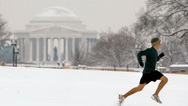 A jogger runs through several inches of snow in front of the Jefferson Memorial in Washington, D.C.