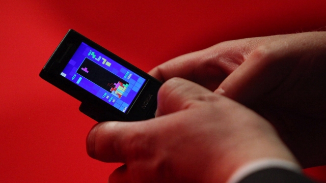 Man playing Tetris on his phone.