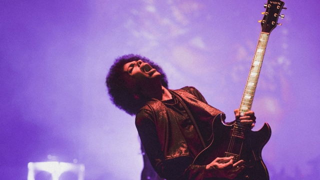Prince plays the guitar while performing in Washington, DC.