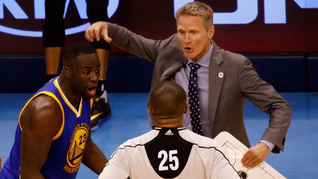 Head coach Steve Kerr and Draymond Green No. 23 of the Golden State Warriors argue with referee Tony Brothers No. 25.