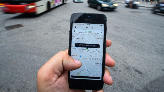 A man uses the Uber app to select a pickup location.