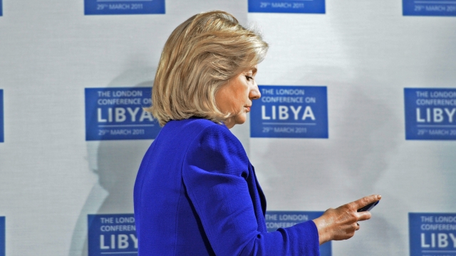 Hillary Clinton checking her phone during a summit in 2011.